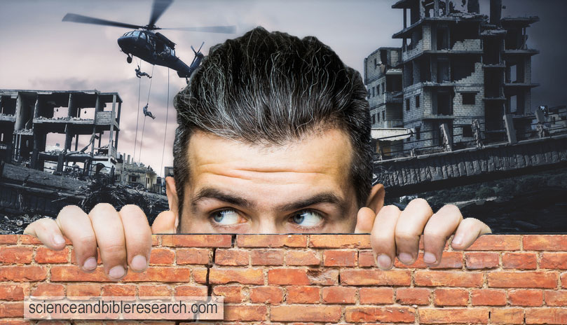 Scared man hiding behind wall (Photo by Tverdohlib.com)